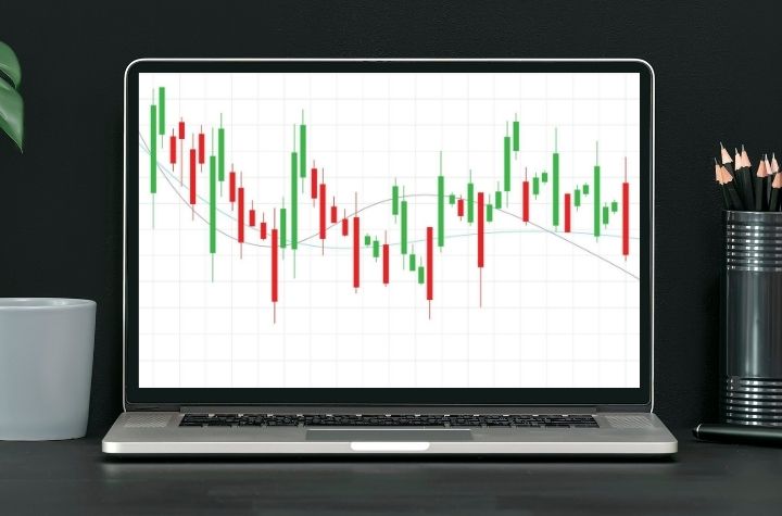 Graph showing candlestick stock chart on laptop, representing BlackRock's tax-smart investing solutions