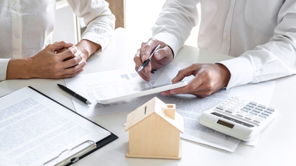 Two professionals reviewing legal structure and financial documents at a desk