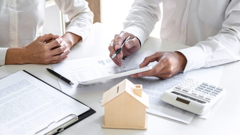 Two professionals reviewing legal structure and financial documents at a desk