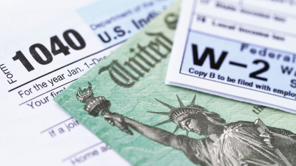 Close-up of US tax forms and Treasury check representing cross-border tax filing for UK expats
