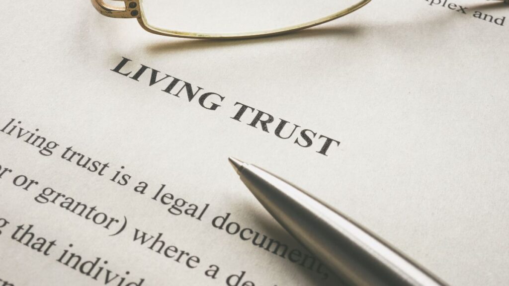 Document labeled “Living Trust” with pen and glasses, representing trust structures and estate planning in the US and UK.