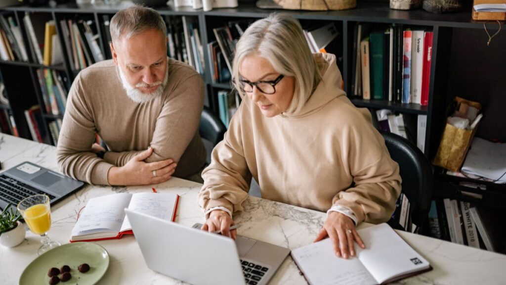 Couple reviewing financial documents and planning their finances together