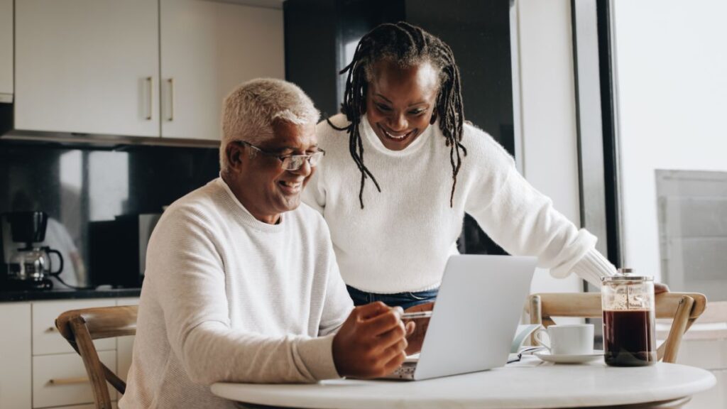 Older couple reviewing financial plans on a laptop at home