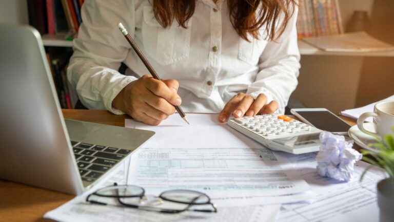Individual reviewing financial documents illustrating tax planning and preparation