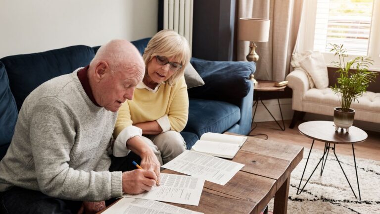Couple reviewing financial documents for UK pension planning after moving to the US